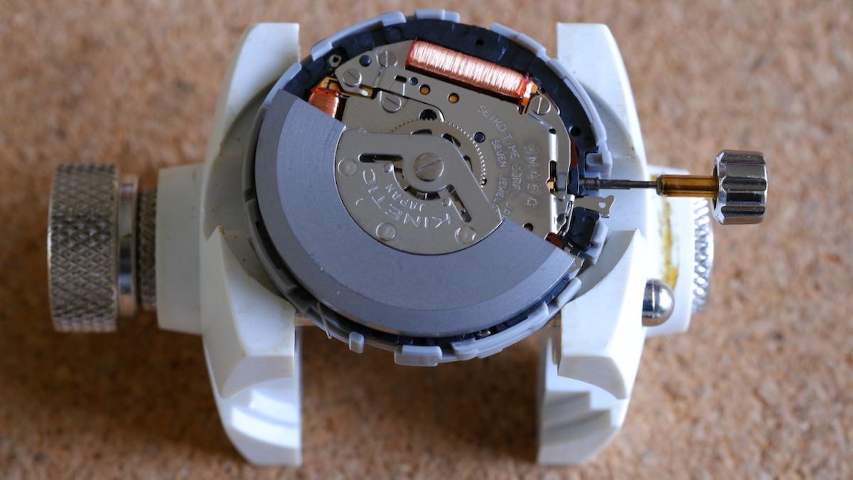 A Seiko 5M45 kinetic movement, out of the watch case and in a movement holder.