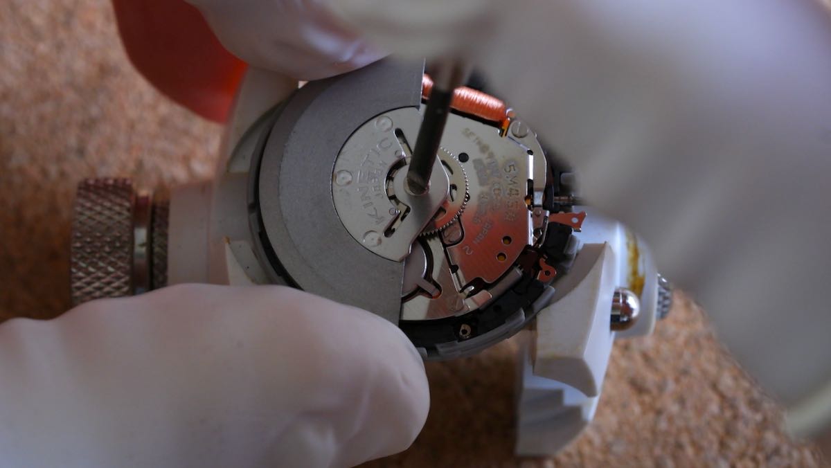 Unscrewing the rotor from a Seiko kinetic movement.