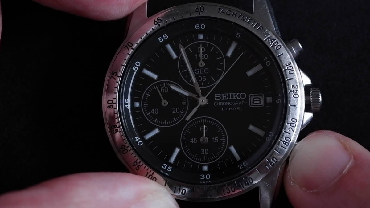 Pressing the bottom pusher on a Seiko 7T92 quartz chronograph watch.