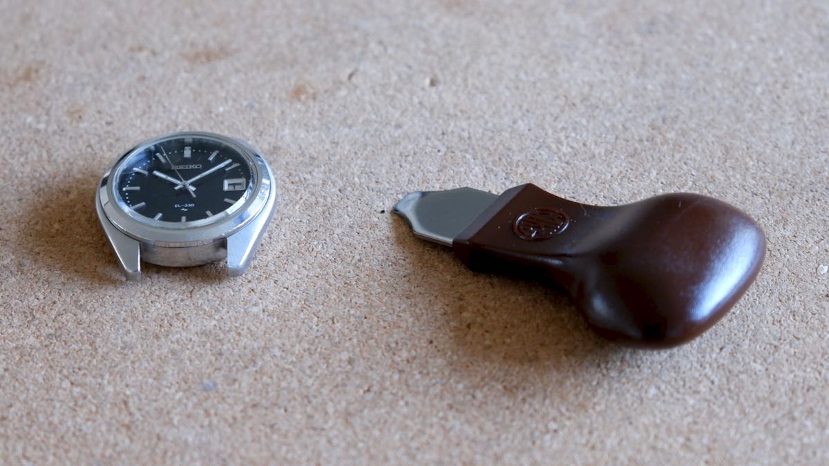 A Seiko watch and a case opening tool