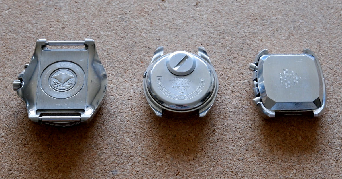 The back of three Seiko watches, all with monocoque cases.