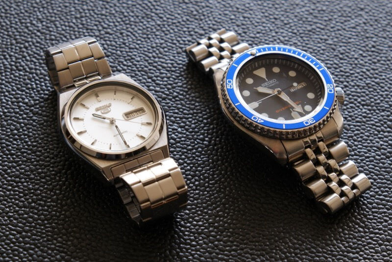 Two Seiko watches with stainless steel bracelets.